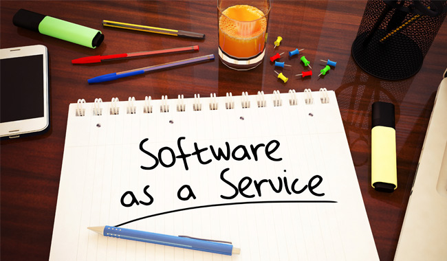 Notebook with ‘Software as a Service’ written on it on a desk.