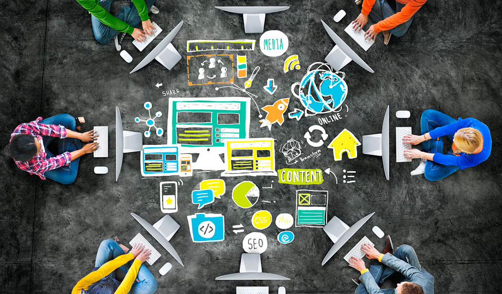 Team of people collaborating around a table with drawn marketing icons.