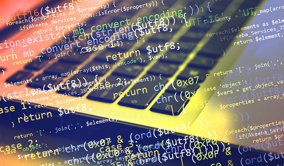 Program code overlaid on a photo of a keyboard.