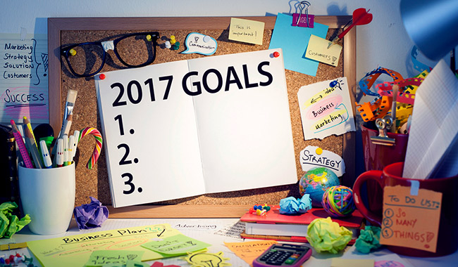 Work desk with a 2017 goal board and notes.
