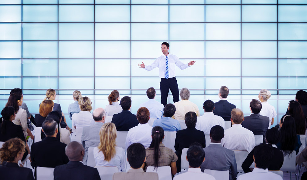 Man giving a presentation to a large audience.