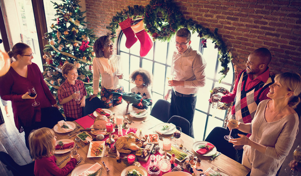Large family gathered at a festive Christmas table.