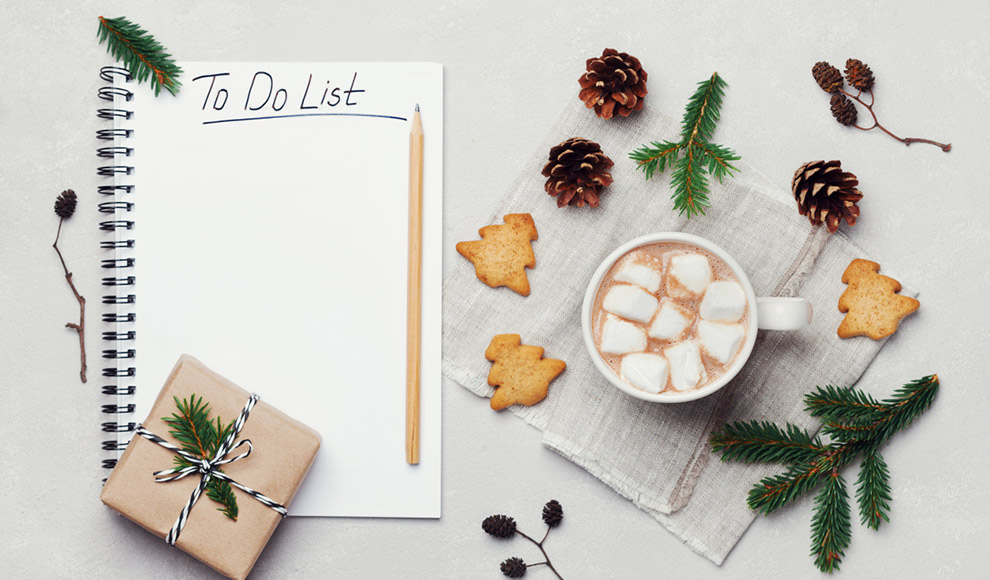 Christmas theme: empty to-do list, cocoa, gift, and pinecones.