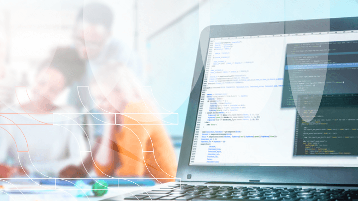 Laptop screen displaying programming code with a blurred office background.