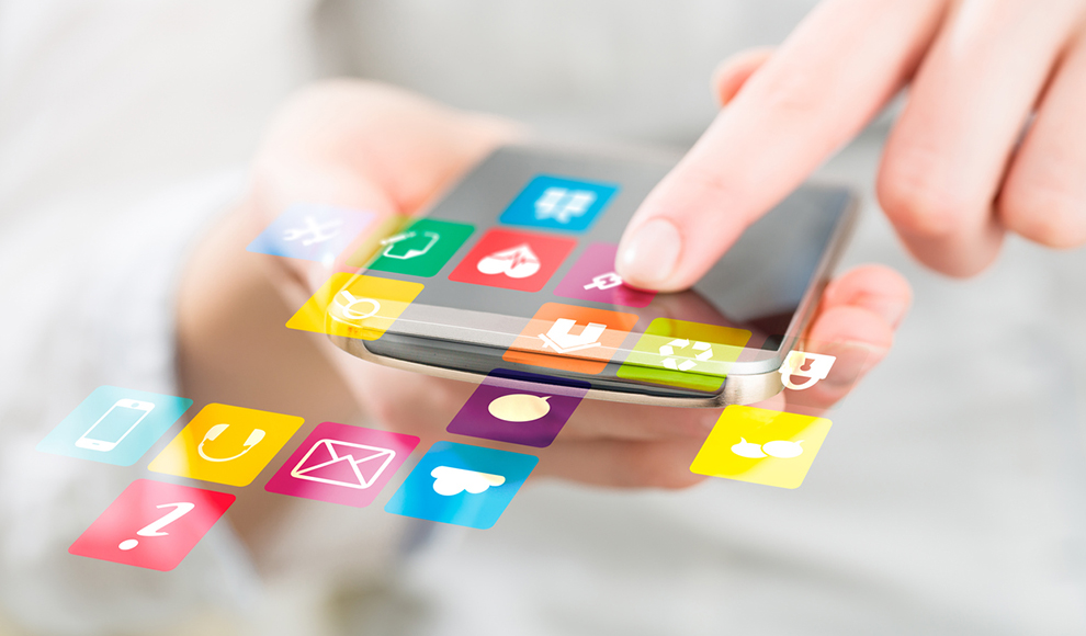 Hand touching a phone screen with multiple floating icons.