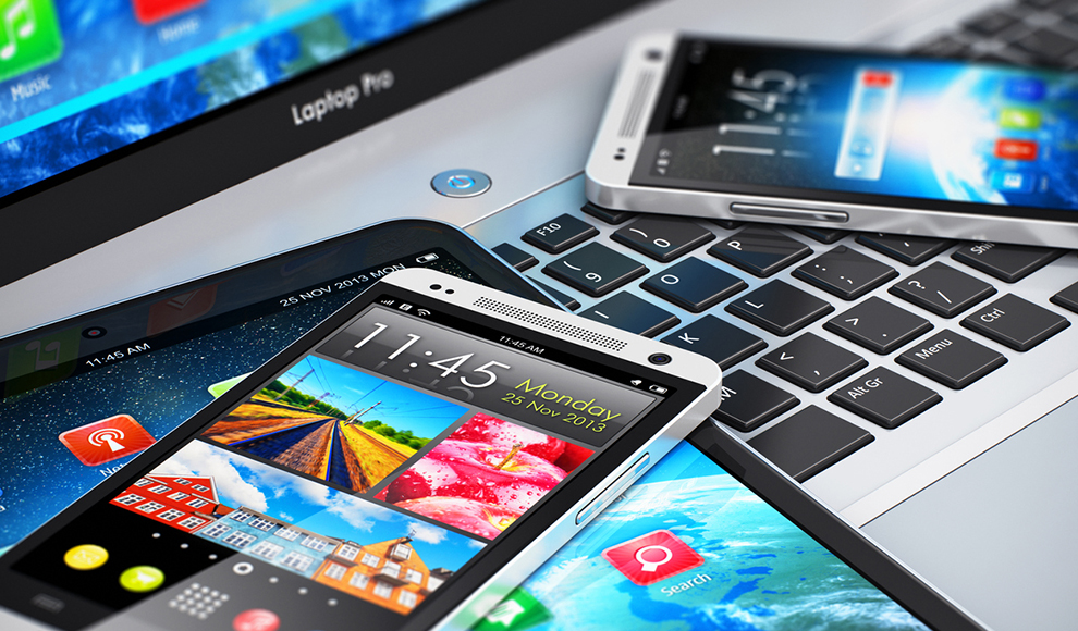 Smartphones placed on a laptop keyboard.