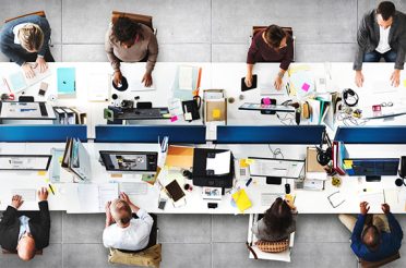 People working at desks in a large office.