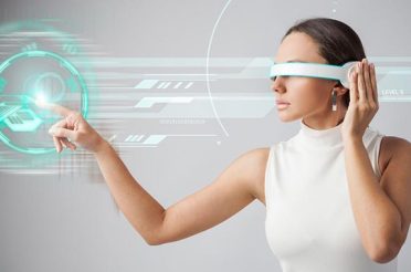 Woman wearing futuristic glasses interacting with a virtual interface in the air.