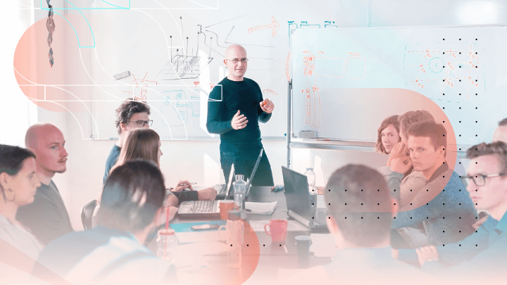 Man giving a presentation to colleagues in an office.