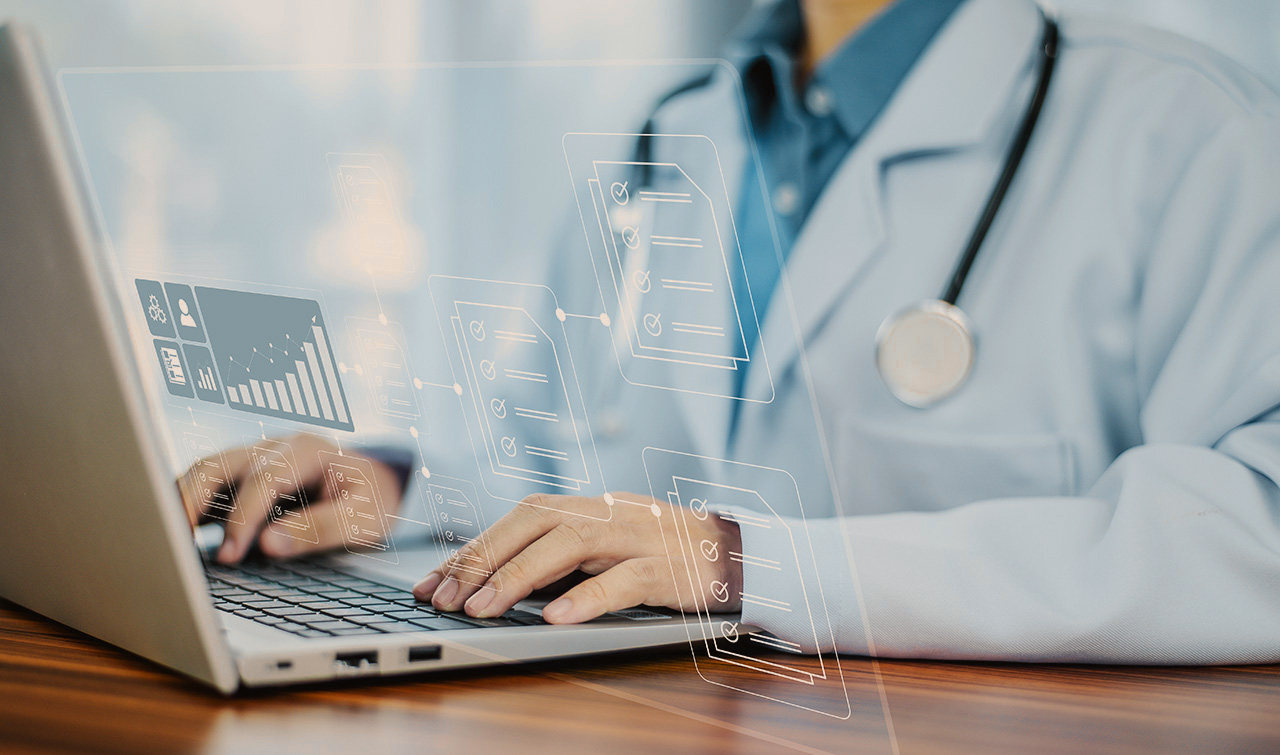 Doctor working on a laptop with holographic icons.