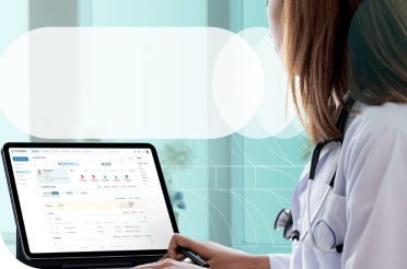 Doctor working on a laptop with electronic medical records.