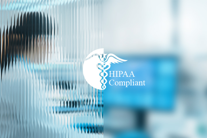 HIPAA Compliant logo through textured glass in a hospital.
