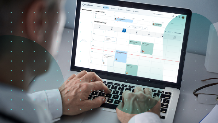 What is Practice Management Software? Doctor using a laptop with a calendar screen for appointment scheduling.