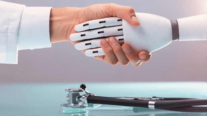 Handshake between a human and a robot at a table with a stethoscope.