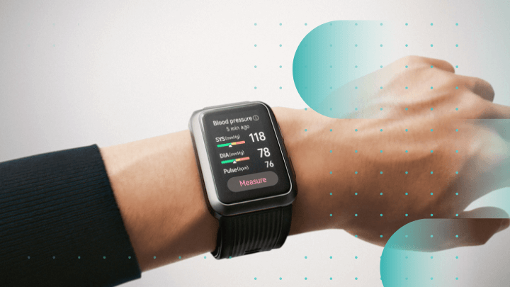 Hand wearing a smartwatch showing blood pressure.
