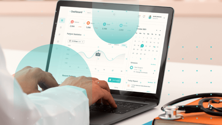 Doctor using patient data software on a laptop.