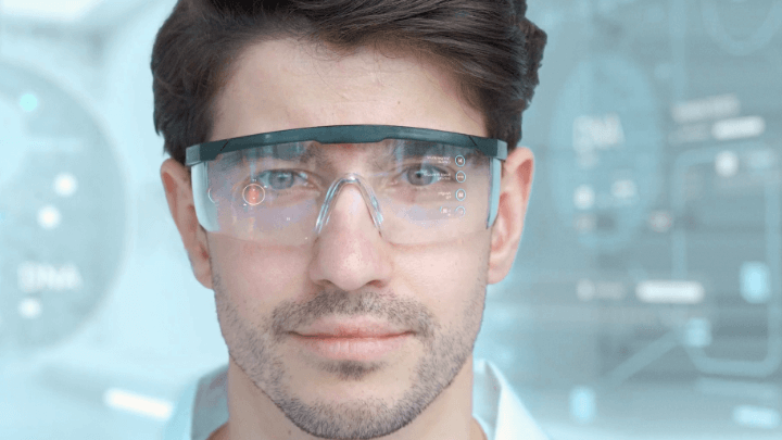 Young man with AR glasses showing medical data.