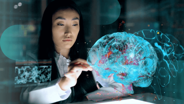 Woman interacting with a hologram of a human brain in a laboratory.