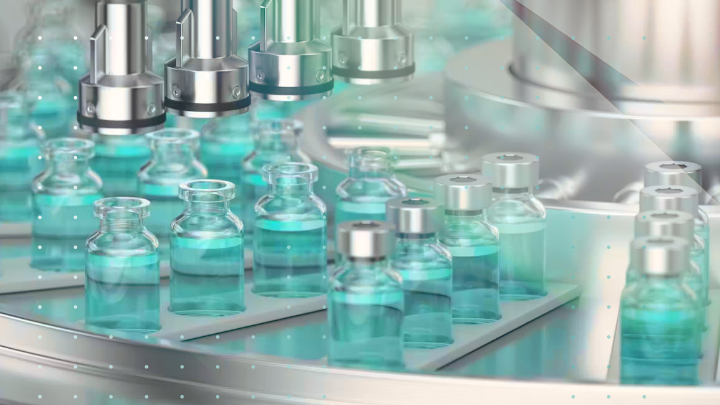 Conveyor belt with vials filled with blue liquid.