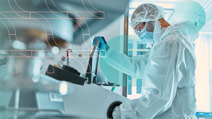 Scientist in protective gear working with laboratory equipment.