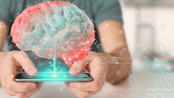 Person using a smartphone projecting a hologram of a brain.