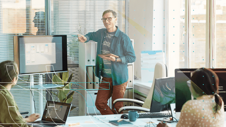 Man giving a presentation to a group of people in an office.