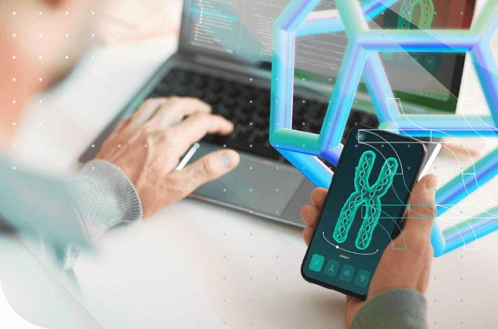 Person using a laptop and smartphone with genetic data.