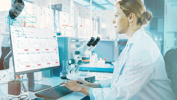 Woman in a laboratory using a computer with scientific data.