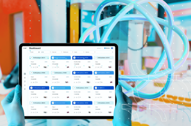 Gloved hands holding a tablet with a data and project management dashboard.