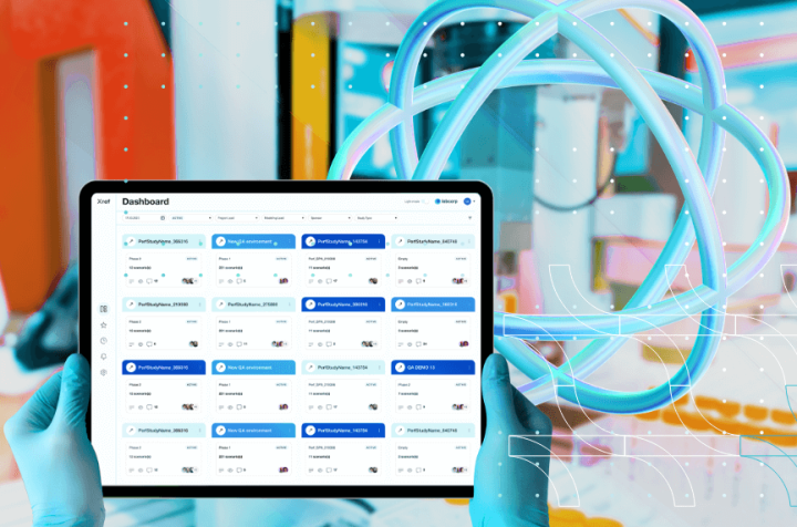 Gloved hands holding a tablet with a data and project management dashboard.