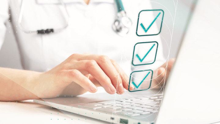 Medicine: doctor’s hands typing on a laptop with a checkmark.