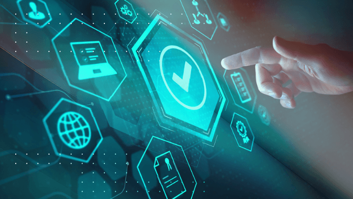 Hand touching a virtual screen with quality symbols.