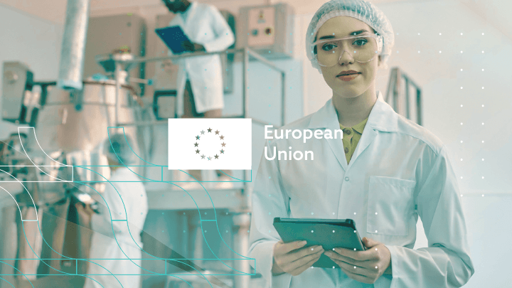 Female scientist with a tablet in a laboratory, European Union logo.