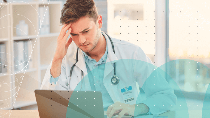 Worried doctor looking at his laptop.