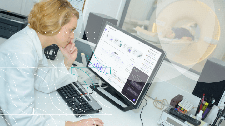 Doctor analyzing data on a computer while a patient is on a scanner.