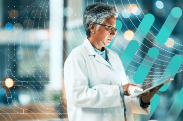 Doctor in a white coat using a tablet in a digital healthcare environment.