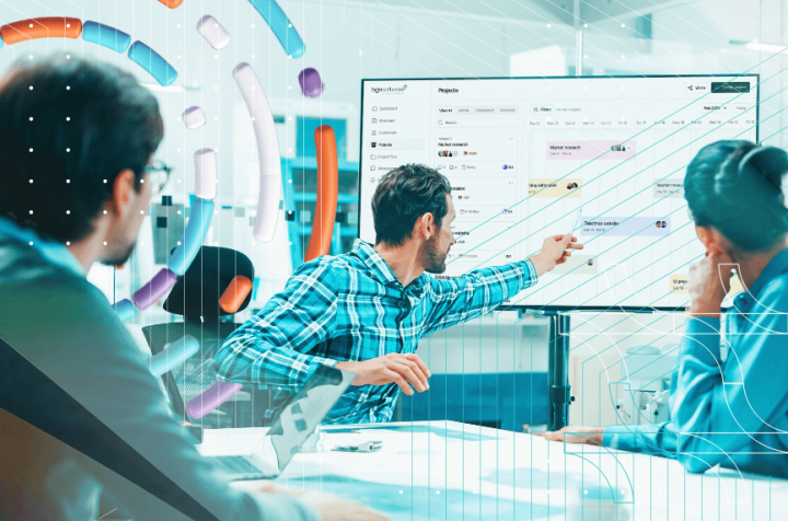 Team working on a large interactive screen in an office.