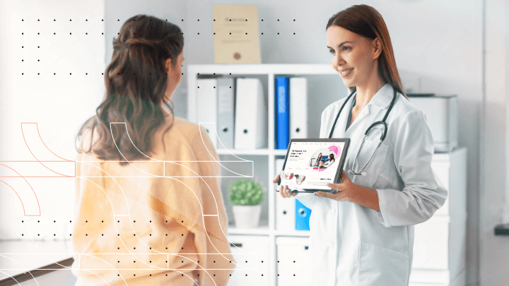 Female doctor showing a screen with information to a patient while talking.