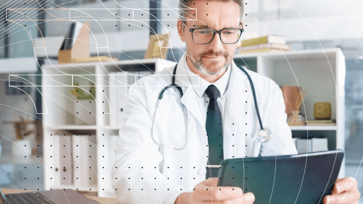 Doctor reviewing medical data on a tablet in their office.