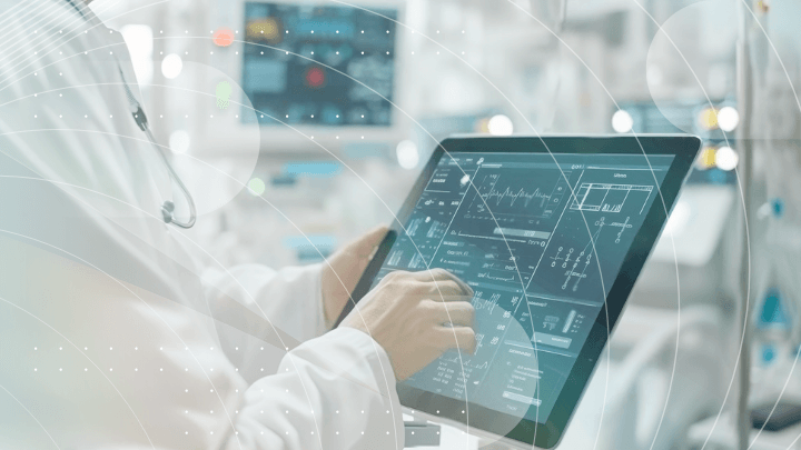 Doctor analyzing medical data and charts on multiple monitors.