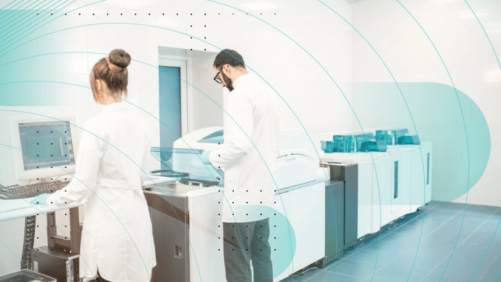 Two scientists working in a laboratory with medical equipment and computers.