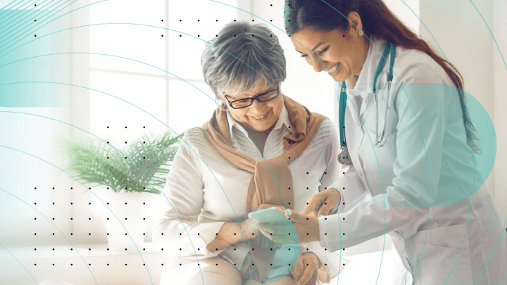 Doctor and elderly patient reviewing results on a smartphone.