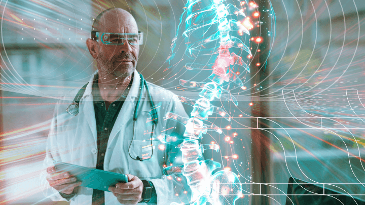 Doctor wearing VR goggles while holding a tablet and viewing a hologram of a spine.