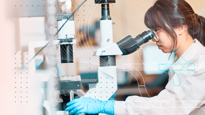 Scientist using a microscope in a laboratory.