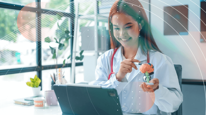 Smiling female doctor showing an anatomical brain model.