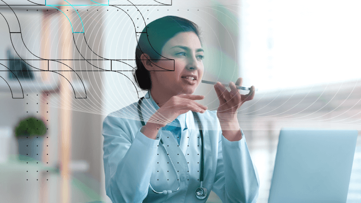 Female doctor talking on the phone while sitting in front of a laptop.