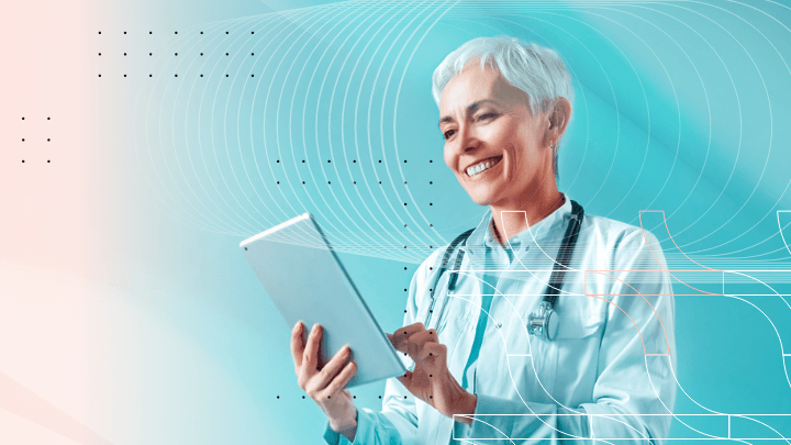 Elderly female doctor with short white hair smiling, holding a tablet.