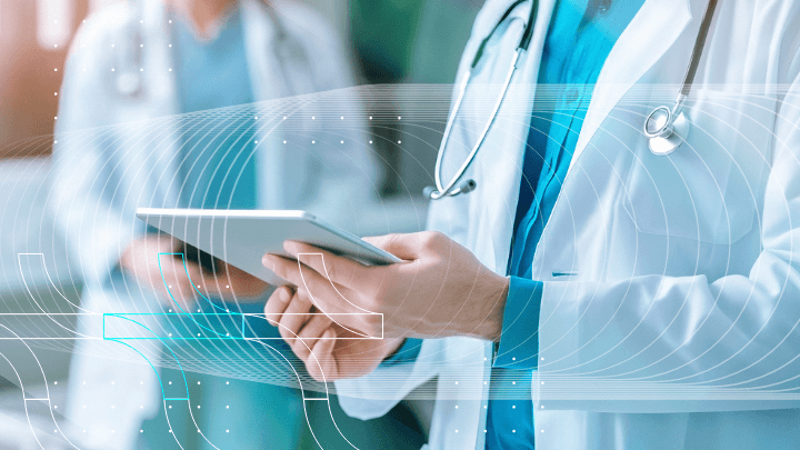 Doctor holding a tablet, reviewing medical information.