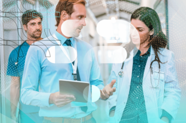 Businessman and doctor discussing data, holding a tablet.