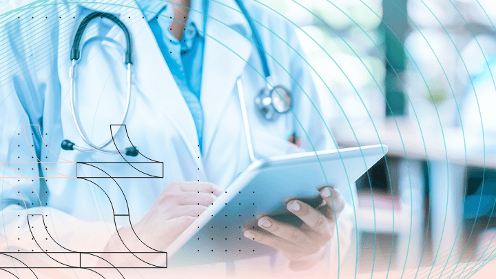 Doctor in a white coat with a stethoscope using a tablet.